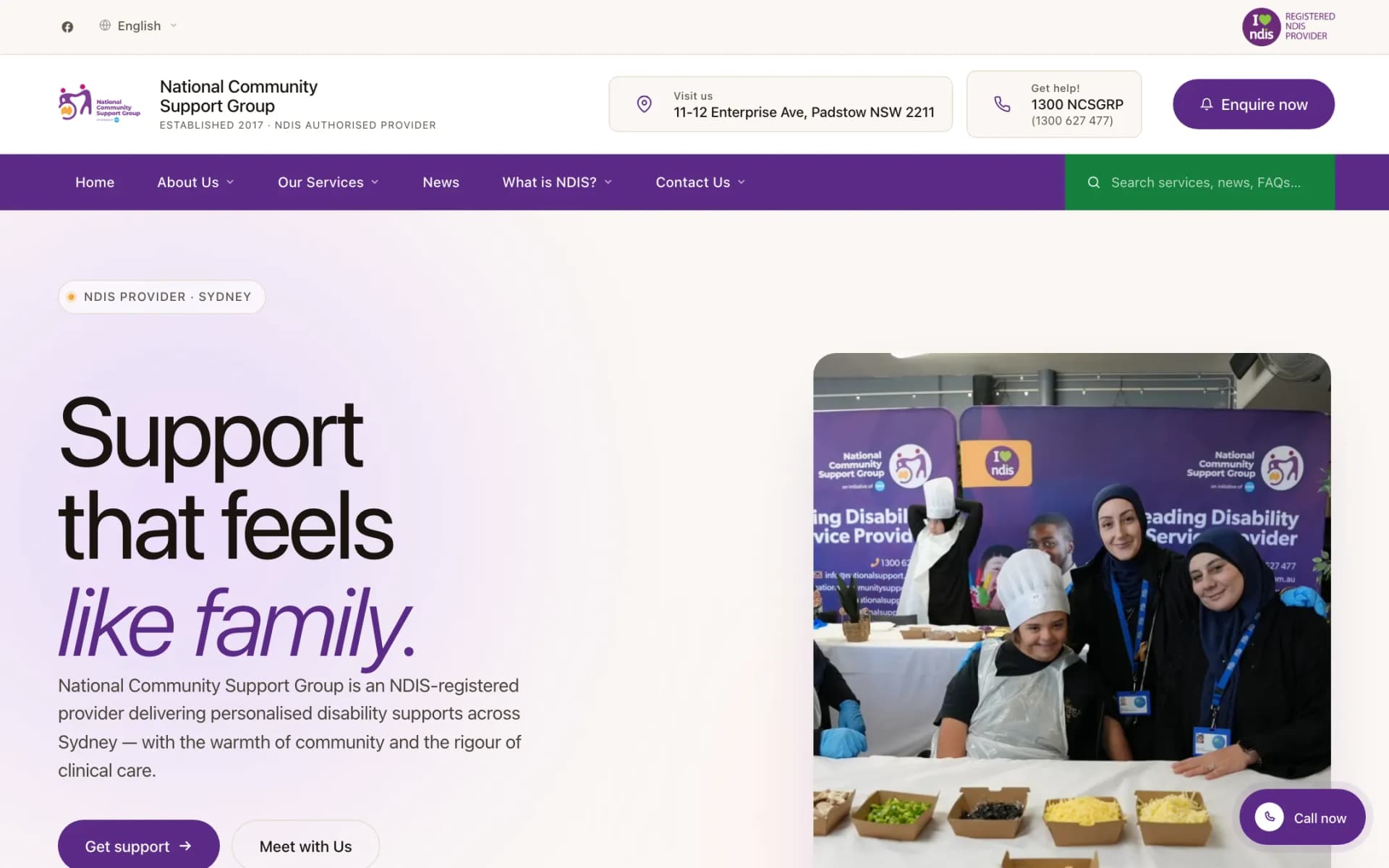 Homepage hero of the National Community Support Group site with the headline 'Support that feels like family.', 'Get support' and 'Meet with Us' buttons, a community event photo, and a purple navigation bar with a green search field